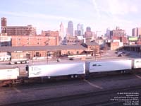 John Christner Trucking and RJW Transport trailers stacked on flat car move on a BNSF train