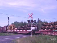 A front loader and a lot of spare wheels go east of Drummondville.