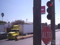 A Freightliner tractor and an Alto sign