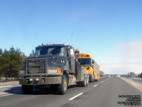 Trucks tows a School bus